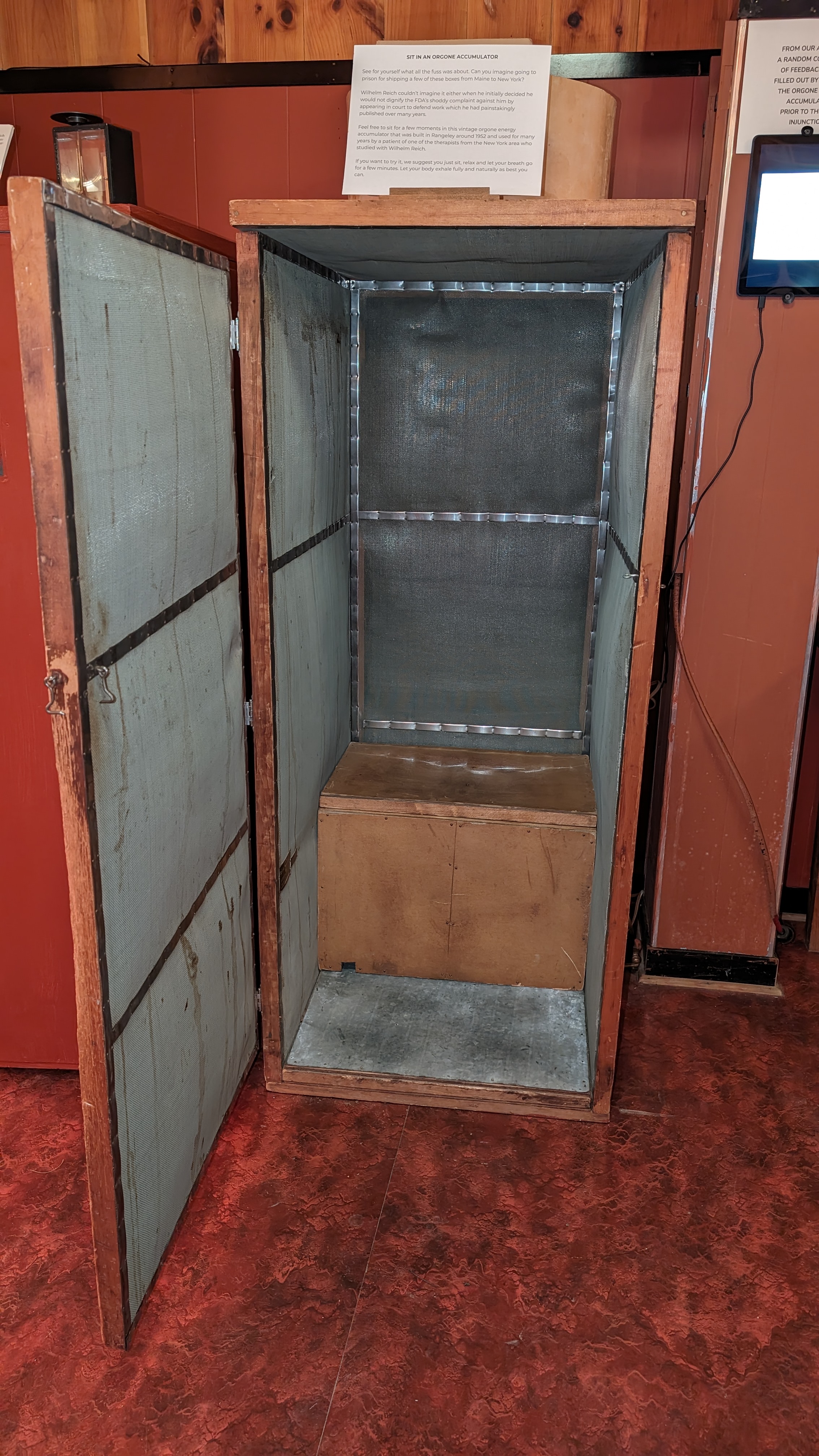 An original box-style orgone accumulator at the Wilhelm Reich Museum, door open to show the galvanized screen lining the interior