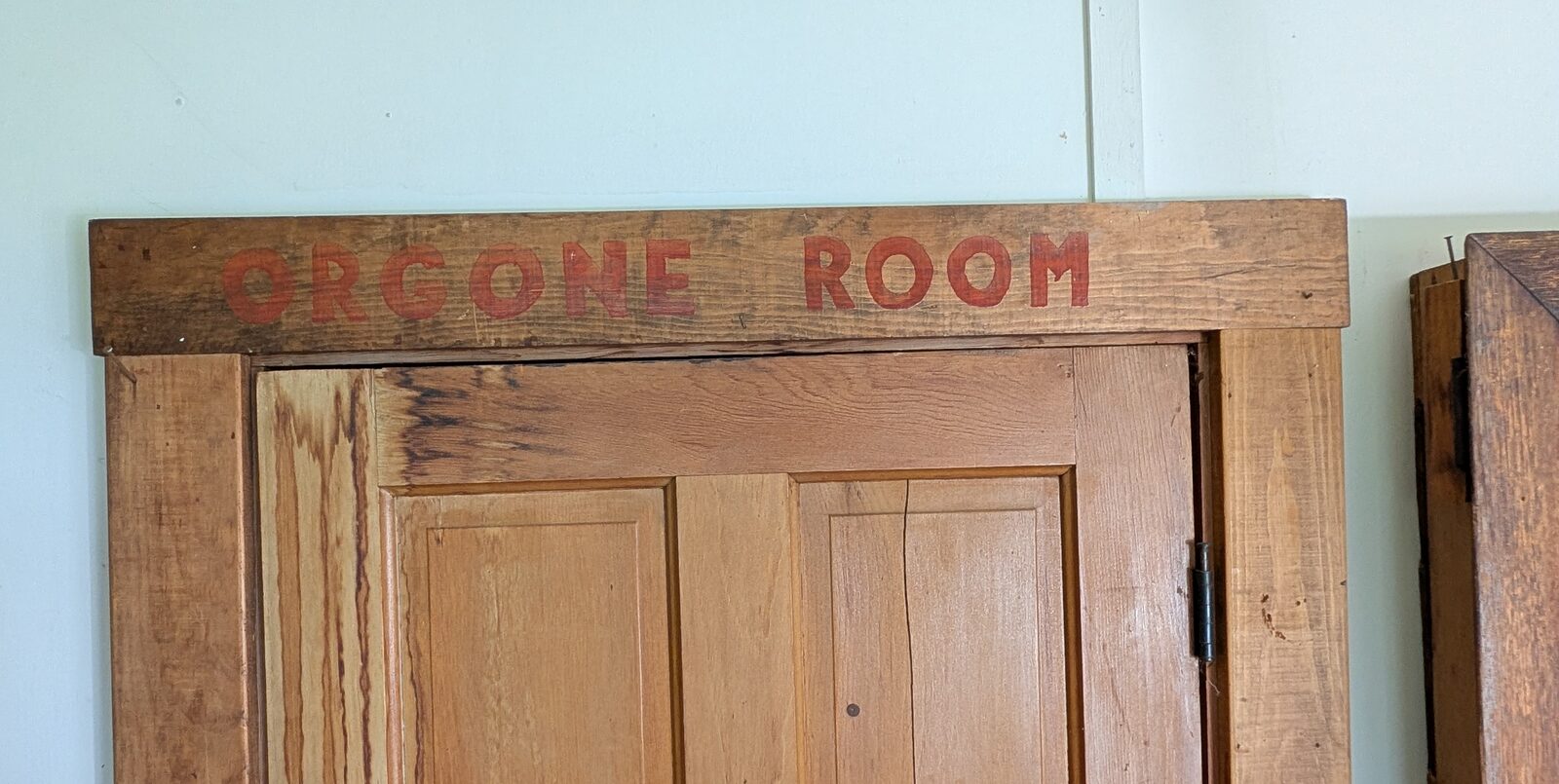 The words ORGONE ROOM painted in red above a wooden door at Orgonon