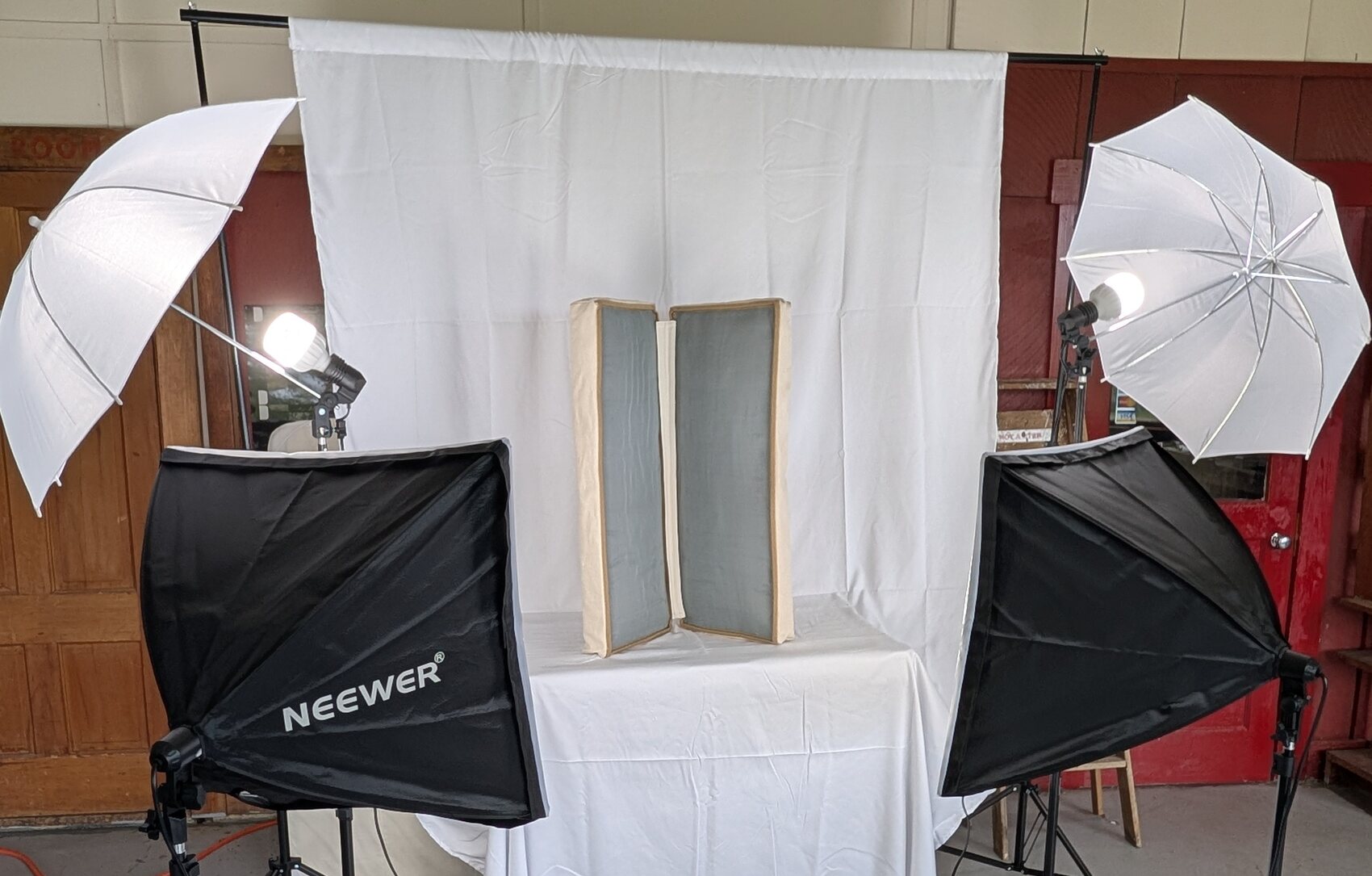 The blanket panels on a draped table between studio lights and umbrellas, set up just outside the Orgone Room